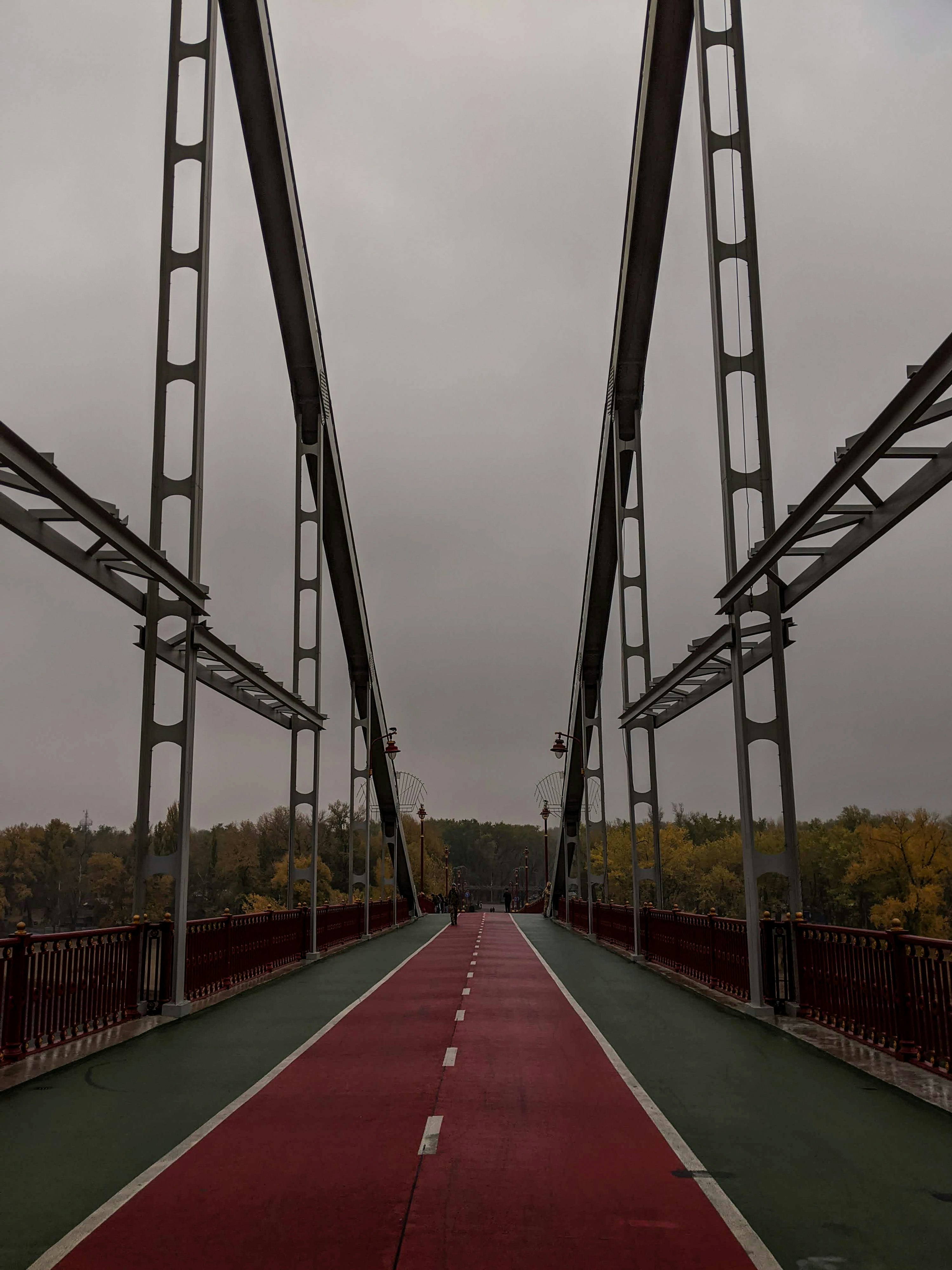 red and white bridge under cloudy sky